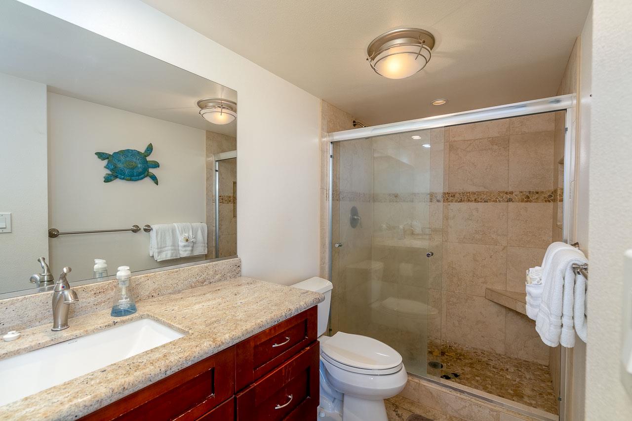 2430 South Kihei Road, Unit 206 Kihei, HI 96753 - Photo 17 of 26 a bathroom with a granite countertop sink toilet and shower