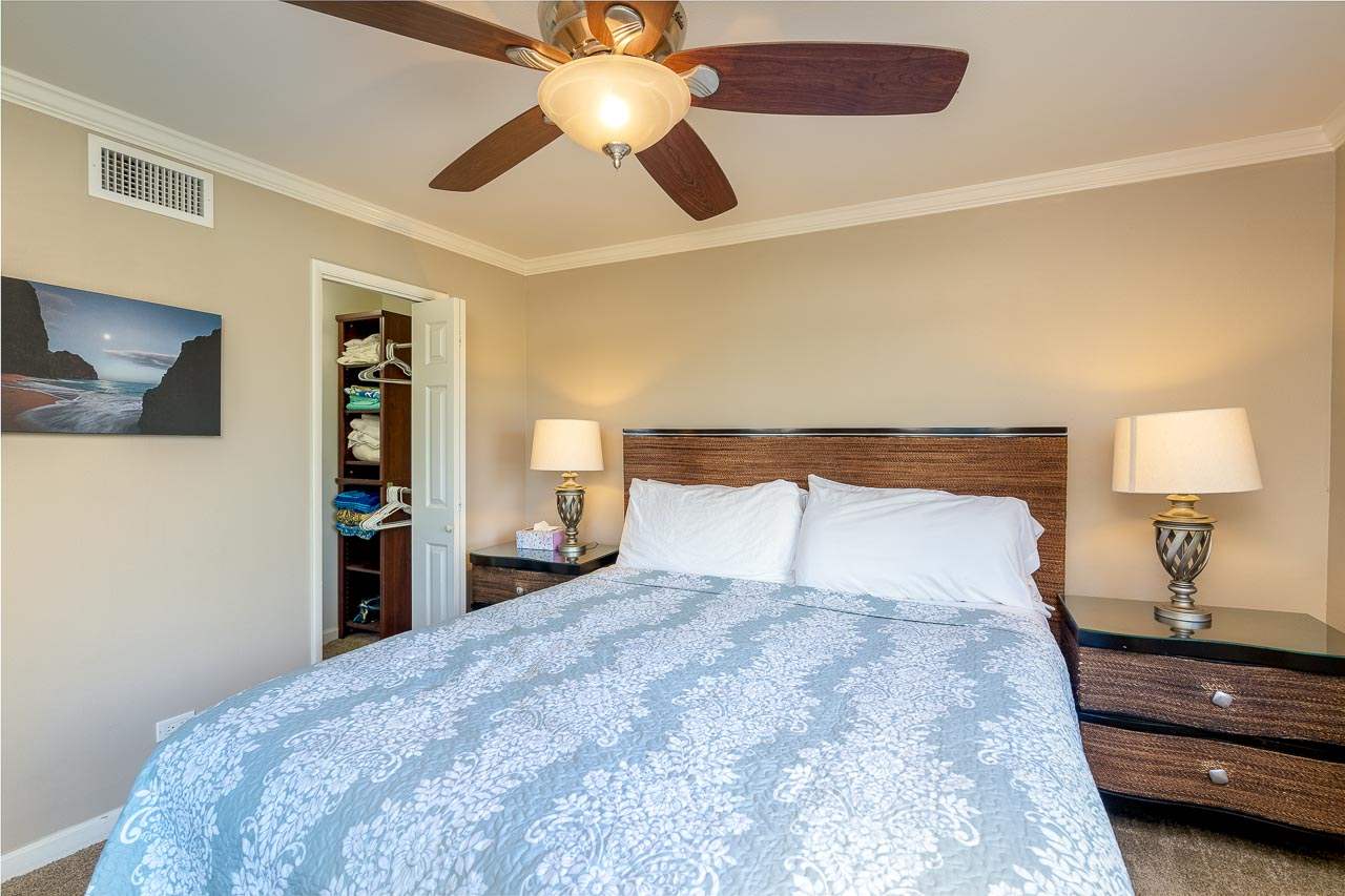 2430 South Kihei Road, Unit 206 Kihei, HI 96753 - Photo 18 of 26 a bedroom with a bed and a lamp