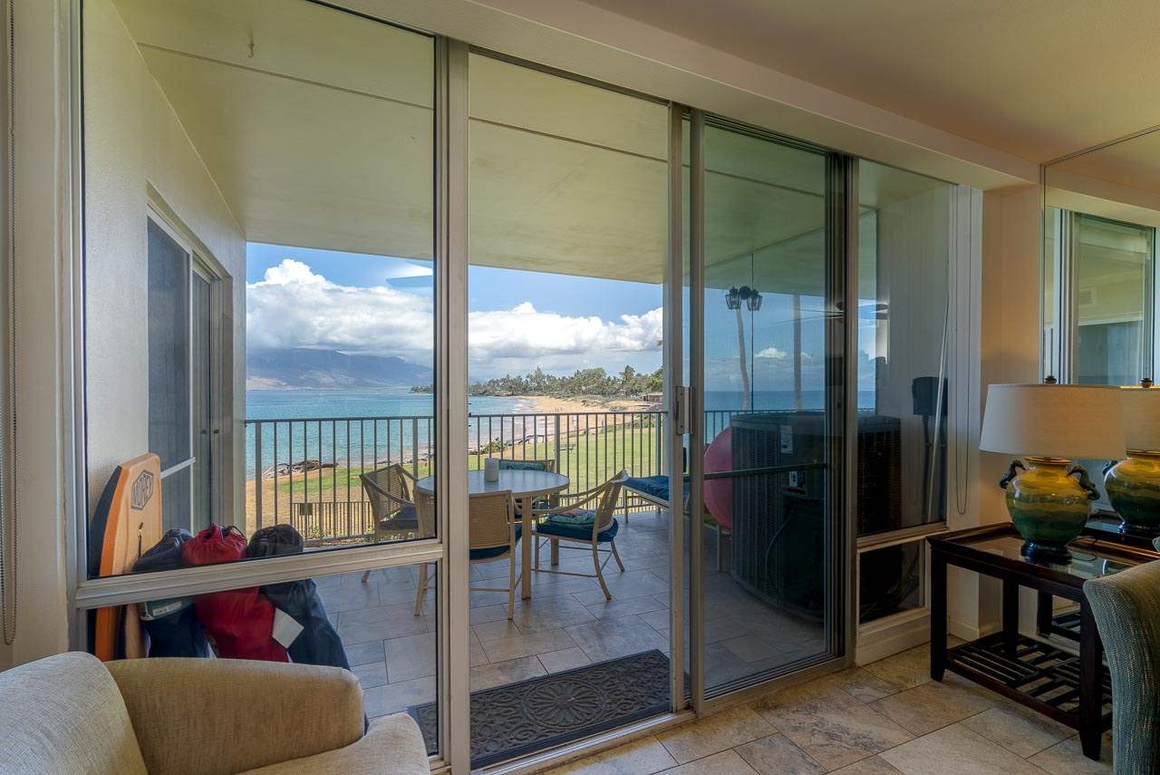2430 South Kihei Road, Unit 206 Kihei, HI 96753 - Photo 3 of 26 a living room with furniture and a floor to ceiling window