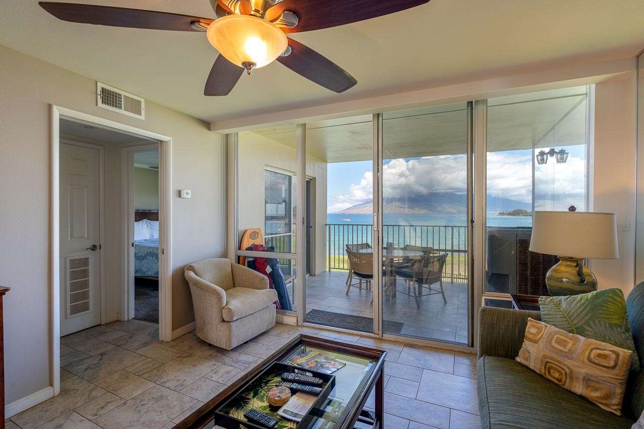 2430 South Kihei Road, Unit 206 Kihei, HI 96753 - Photo 4 of 26 a living room with furniture and a chandelier