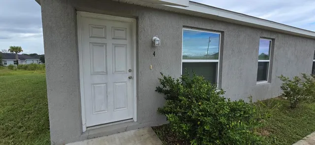 a view of a house with a small yard