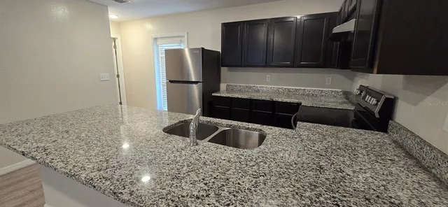 a kitchen with a refrigerator and a sink