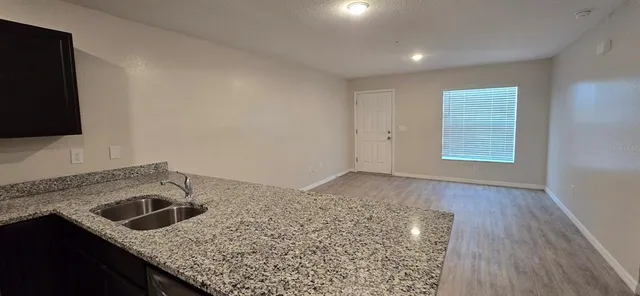 a kitchen with a sink and a stove top oven