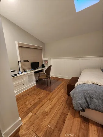 a bedroom with a bed and a night stand