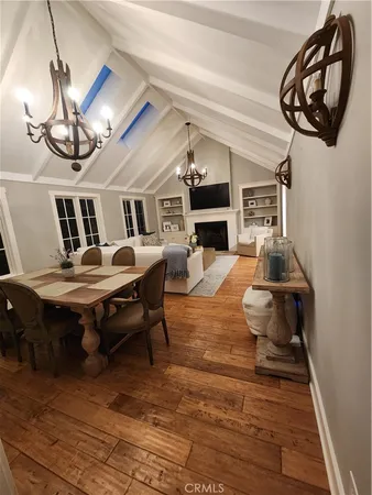a living room with furniture a chandelier and a fireplace