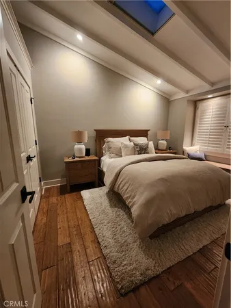 a living room with furniture a dining table and paintings on the wall