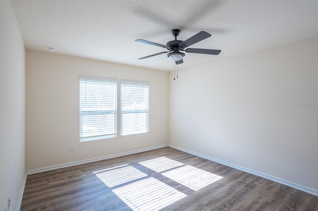 9 Grand Par Court Bunnell, FL 32110 - Photo 12 of 24 a view of empty room with wooden floor and fan