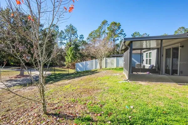 a view of a house with backyard and sitting area