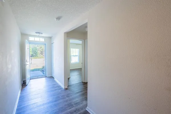 a view of a hallway with wooden floor