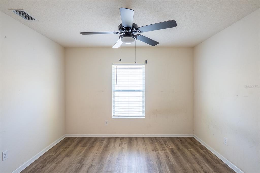 9 Grand Par Court Bunnell, FL 32110 - Photo 9 of 24 an empty room with a window and a fan