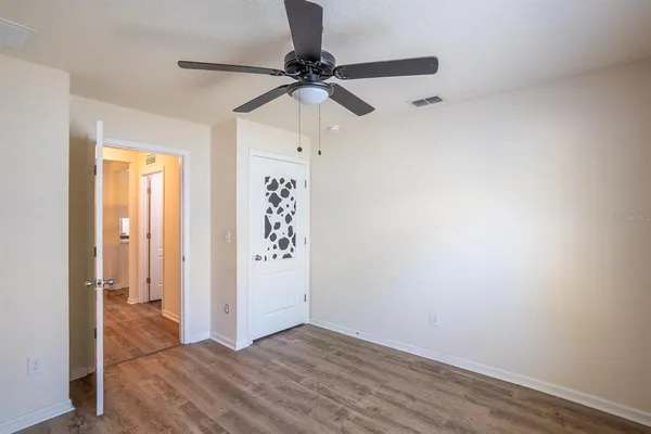 a view of a room with wooden floor closet and windows