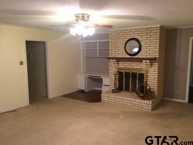 201 Clemson Drive Tyler, TX 75703 - Photo 5 of 9 a view of fireplace with washer and dryer