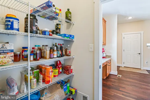 a view of a dining room with furniture wooden floor and chandelier