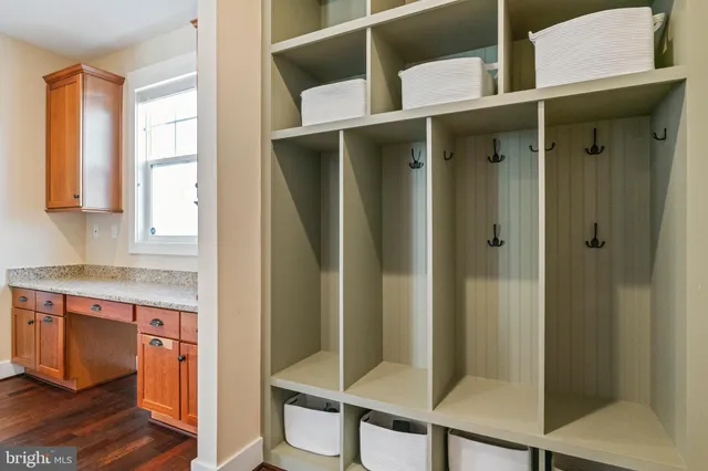 a bathroom with a granite countertop double vanity sink mirror and toilet