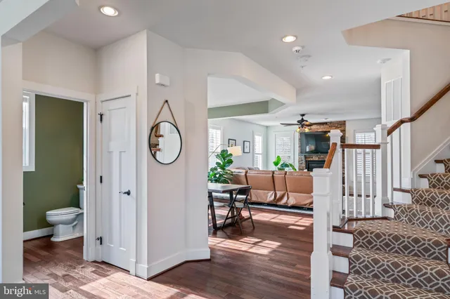 a kitchen with stainless steel appliances granite countertop wooden floors and wooden cabinets