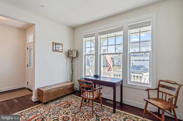 a bathroom with a sink a mirror and a painting on the wall