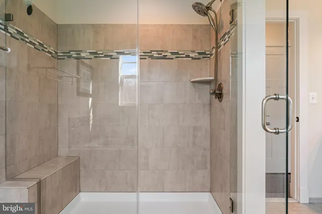 a bathroom with a mirror and a shower
