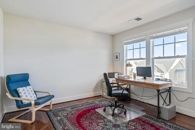 a front view of a house with a garden and patio