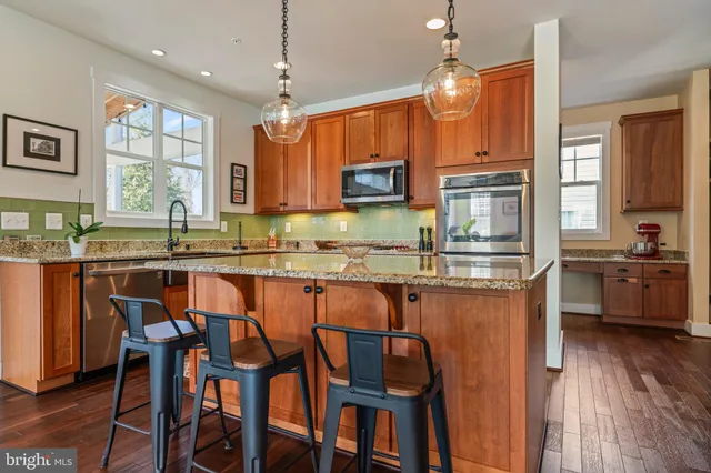 a kitchen with stainless steel appliances granite countertop a stove and a sink