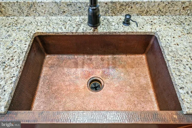 a kitchen with stainless steel appliances granite countertop a refrigerator and a stove