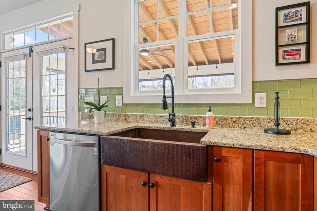 a kitchen with stainless steel appliances granite countertop a sink and a window