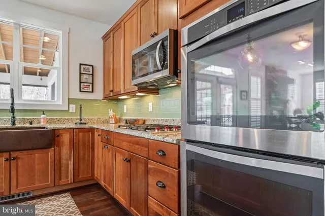 a utility room with stainless steel appliances and white walls