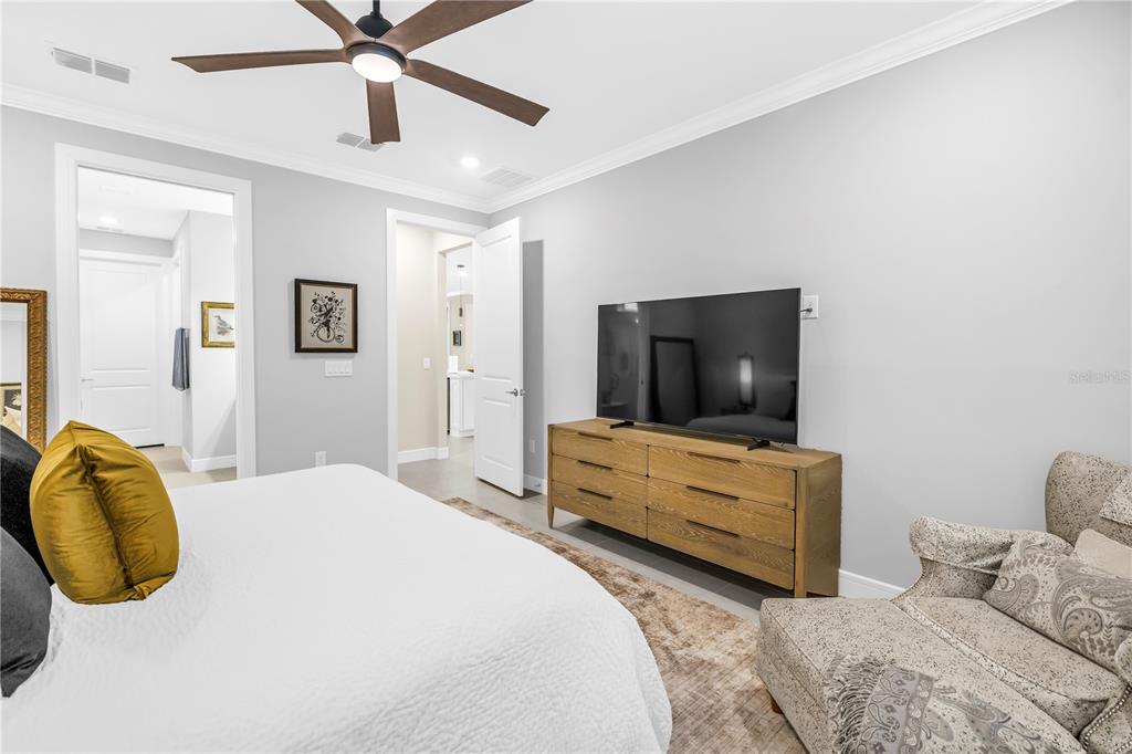 10735 Spring Tide Way Palmetto, FL 34221 - Photo 21 of 41 a bedroom with a bed and a flat screen tv