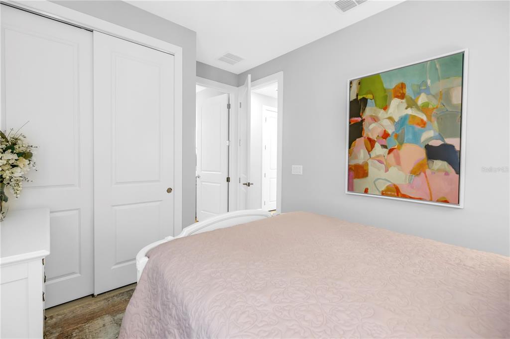 10735 Spring Tide Way Palmetto, FL 34221 - Photo 25 of 41 a bedroom with a bed and a painting on the wall