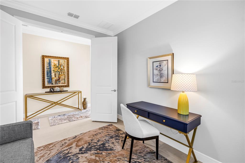 10735 Spring Tide Way Palmetto, FL 34221 - Photo 28 of 41 a living room with a couch and a dresser with wooden floor