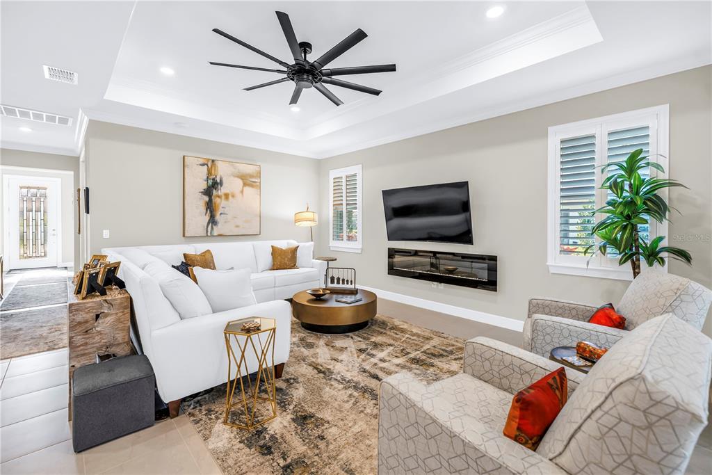 10735 Spring Tide Way Palmetto, FL 34221 - Photo 4 of 41 a living room with furniture and a flat screen tv