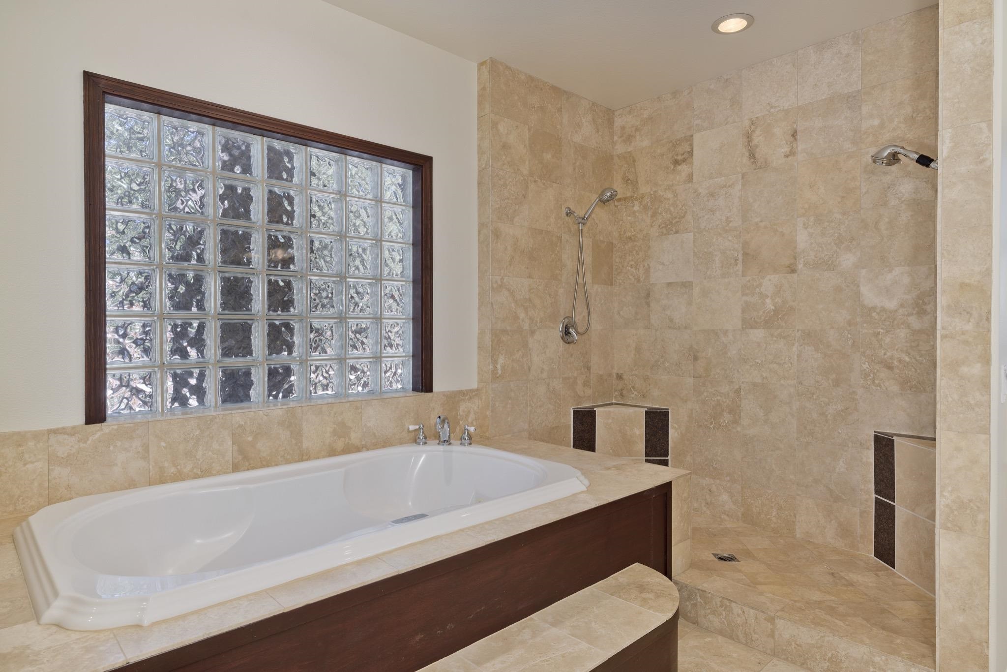 378 Ridge Way Mammoth Lakes, CA 93546 - Photo 26 of 43 Built-in soaking tub with deck-mounted faucet and a glass block window