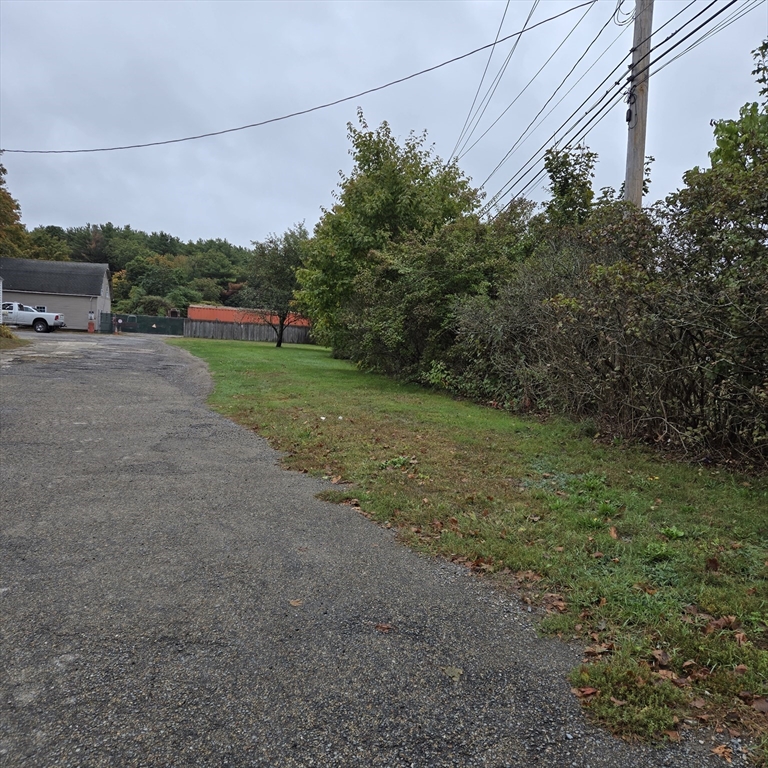 304 Cox Street Hudson, MA 01749 - Photo 2 of 2 a view of a big yard with potted plants