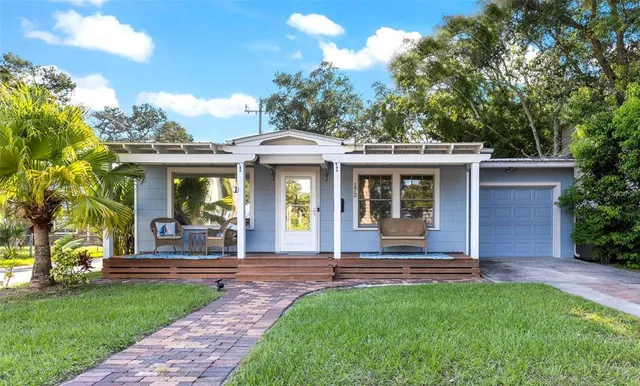 a front view of a house with a garden