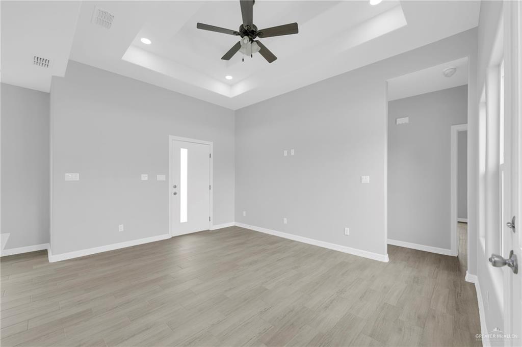 504 Bridget Street Weslaco, TX 78596 - Photo 11 of 23 wooden floor in an empty room with a window