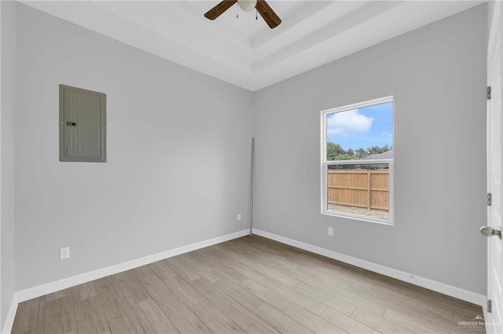 504 Bridget Street Weslaco, TX 78596 - Photo 16 of 23 an empty room with a window and a ceiling fan