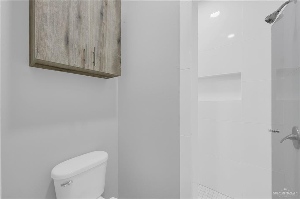 504 Bridget Street Weslaco, TX 78596 - Photo 18 of 23 a white toilet sitting next to a shower