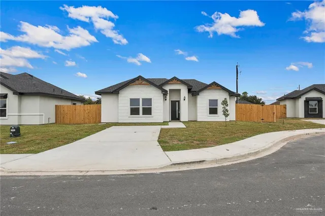 a view of a house with a yard and garage