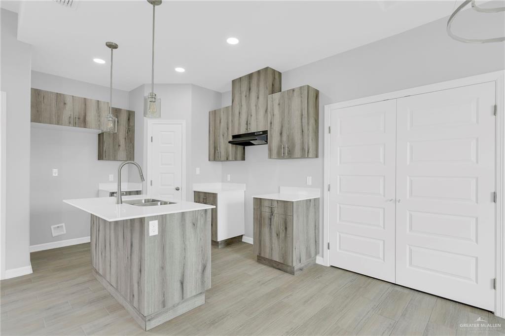 504 Bridget Street Weslaco, TX 78596 - Photo 6 of 23 a kitchen with kitchen island a sink stainless steel appliances and cabinets