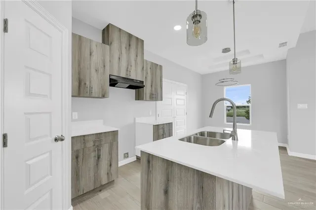 a kitchen with a sink a stove and cabinets