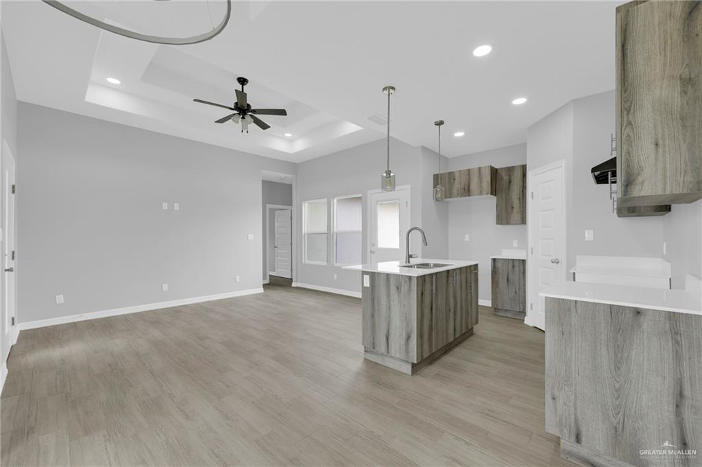 504 Bridget Street Weslaco, TX 78596 - Photo 8 of 23 a large kitchen with a lot of counter space and wooden floor