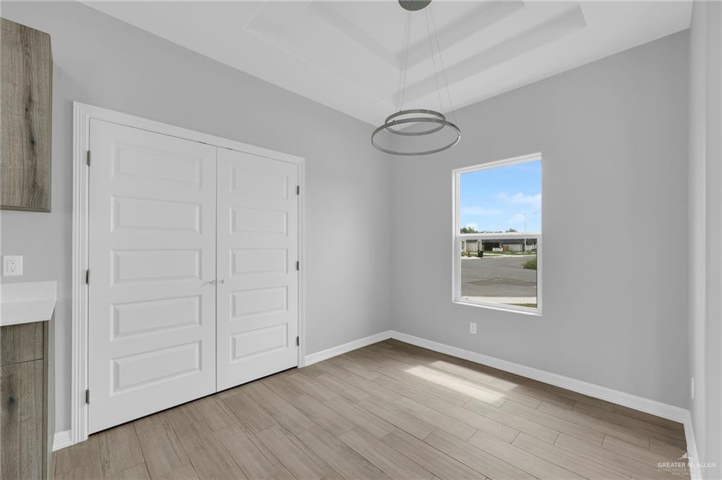 504 Bridget Street Weslaco, TX 78596 - Photo 9 of 23 a view of a room with wooden floor and white doors