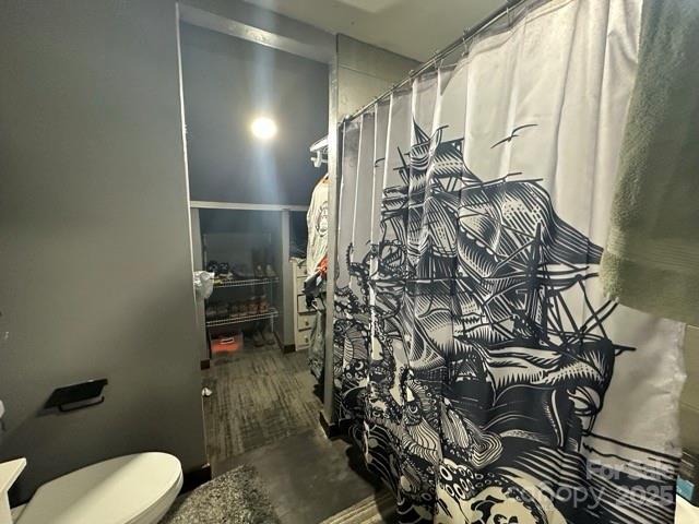 610 Old Dutch Road West Indian Trail, NC 28079 - Photo 20 of 30 a bathroom with a toilet and shower curtain
