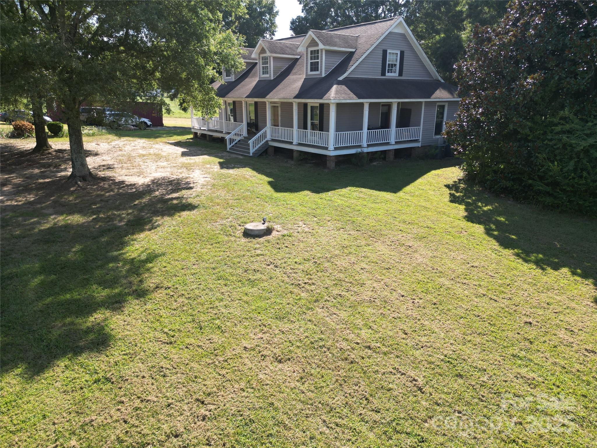 610 Old Dutch Road West Indian Trail, NC 28079 - Photo 2 of 30 a front view of a house with a yard covered with trees