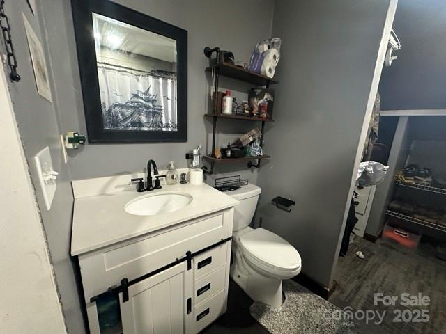 610 Old Dutch Road West Indian Trail, NC 28079 - Photo 21 of 30 a bathroom with a toilet sink and mirror
