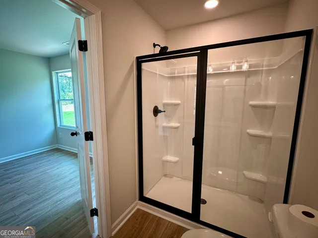 a bathroom with a glass shower door