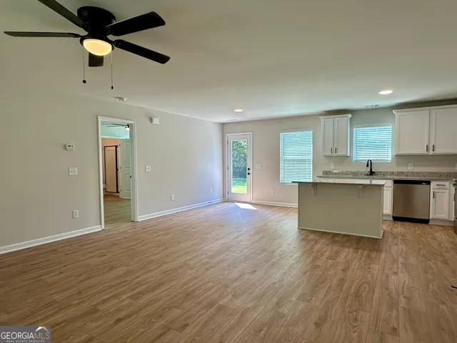 a view of kitchen with wooden floor and window