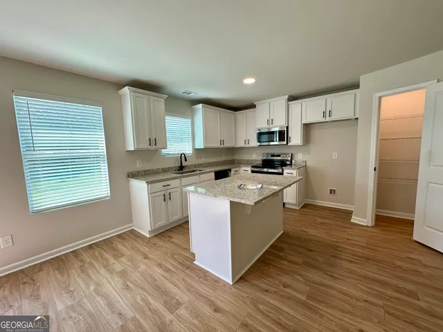 a kitchen with a sink a counter top space and appliances