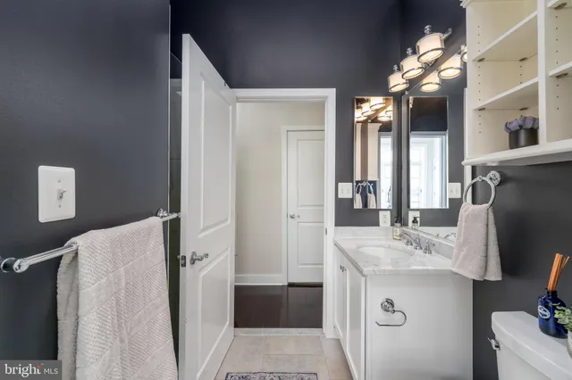 a bathroom with a sink vanity tub and shower