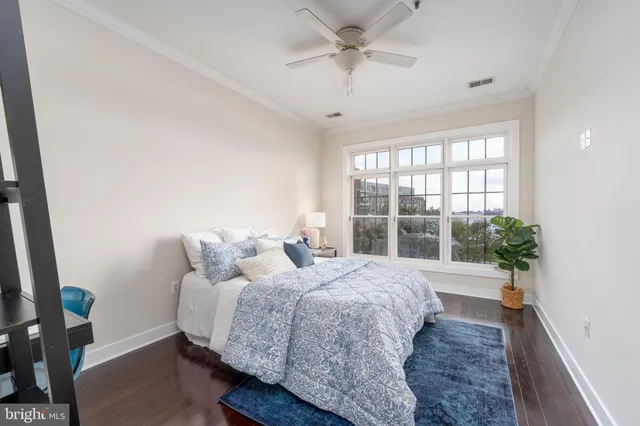 a spacious bedroom with a bed and a large window