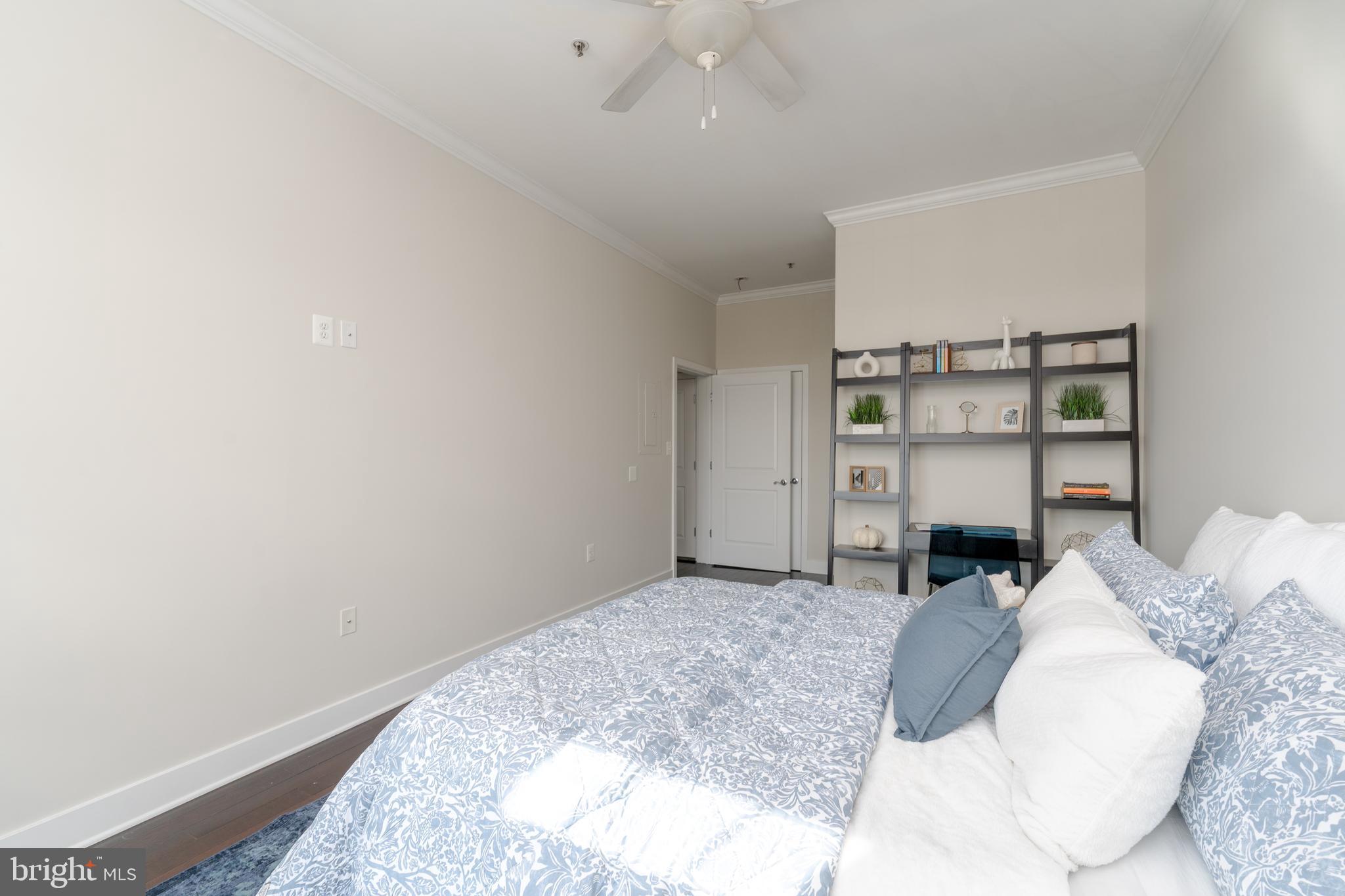 1500 Thames Street, Unit 401 Baltimore, MD 21231 - Photo 18 of 54 a bedroom with a bed and a cabinets